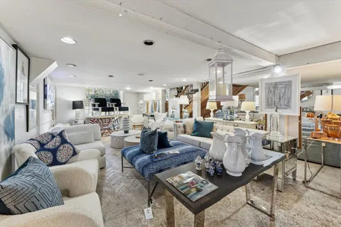 a living room with lots of furniture and view of kitchen