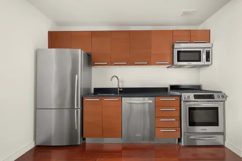 a kitchen with stainless steel appliances a refrigerator a stove and a microwave