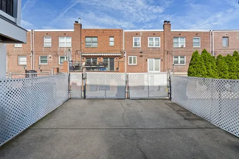 a view of a brick house with many windows