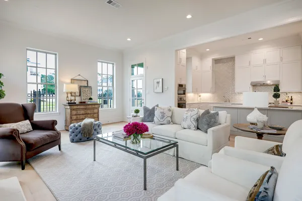 a living room with furniture and kitchen view