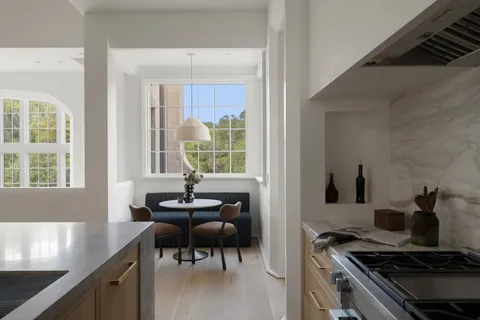 a kitchen with granite countertop a sink and cabinets
