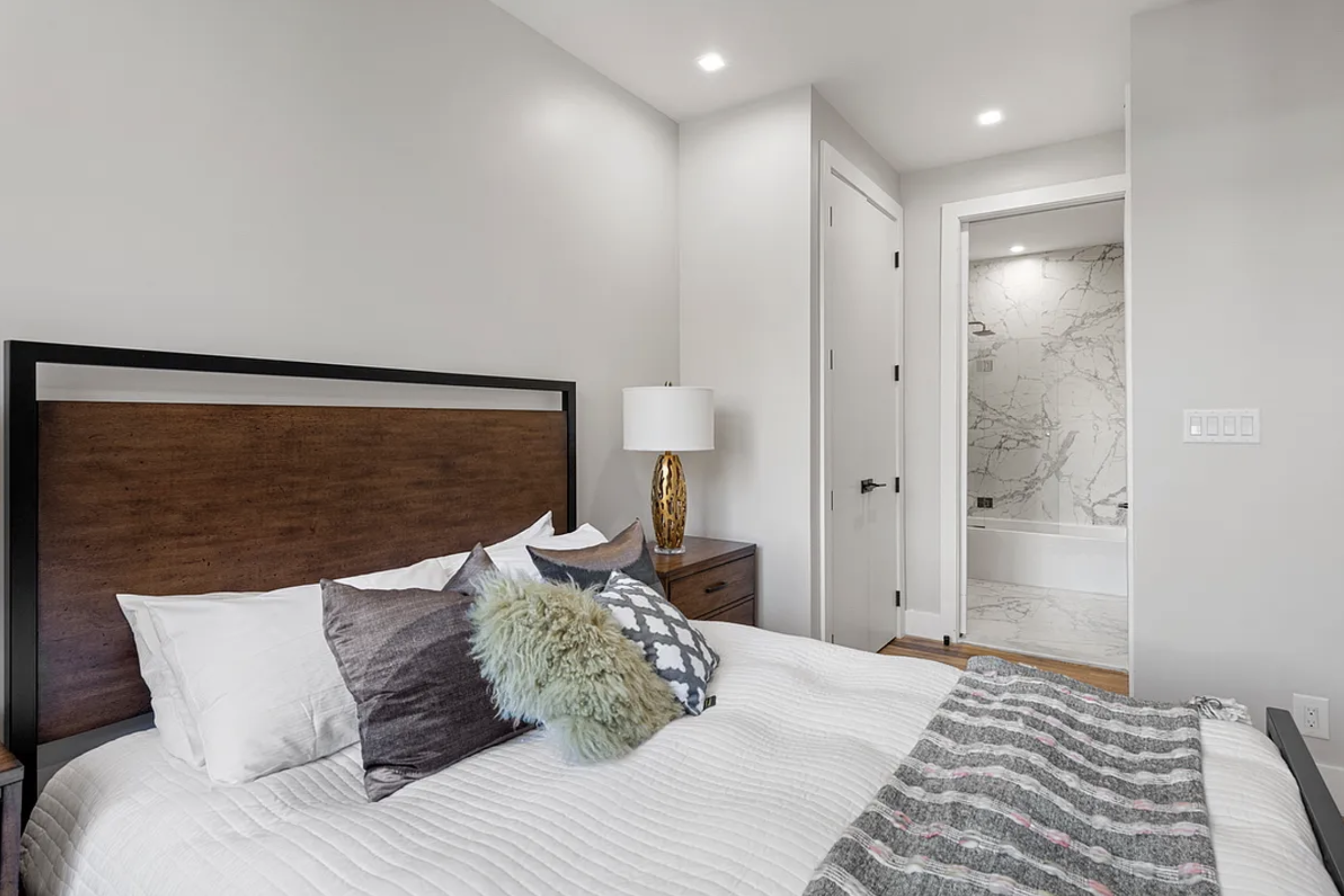 371 Lincoln Road, Unit 2 Brooklyn, NY 11225 - Photo 9 of 19 a bedroom with a large bed and a chandelier