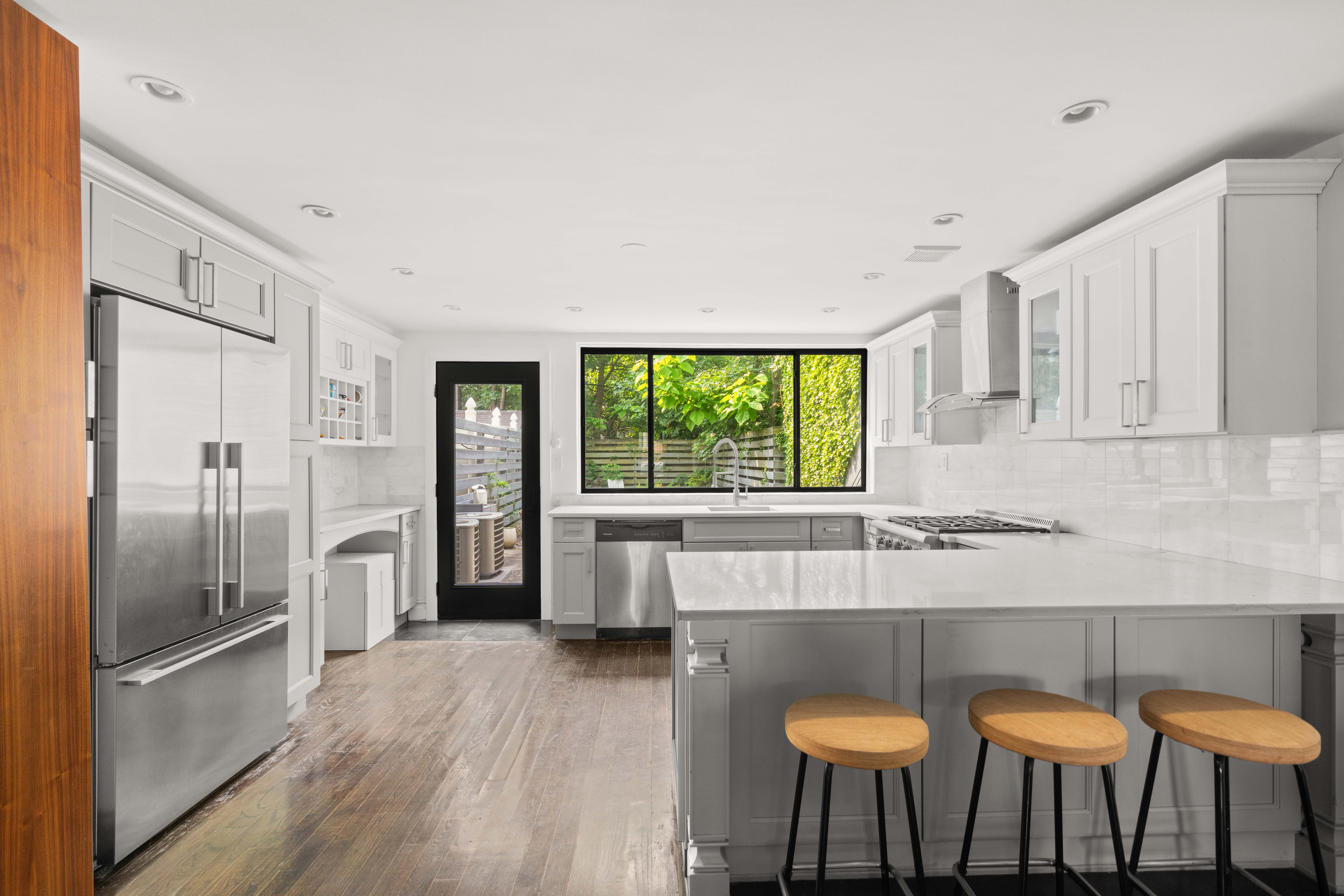 748 Madison Street, Unit 1 Brooklyn, NY 11221 - Photo 2 of 10 a kitchen with stainless steel appliances granite countertop a kitchen island hardwood floor and a sink