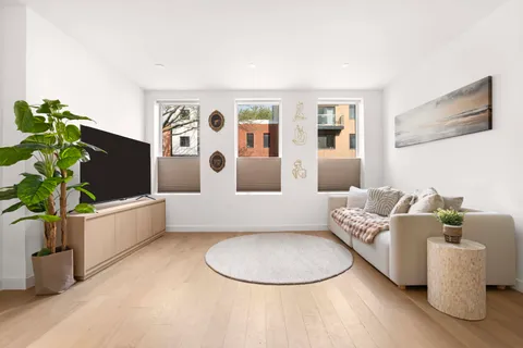 a living room with furniture and flowers