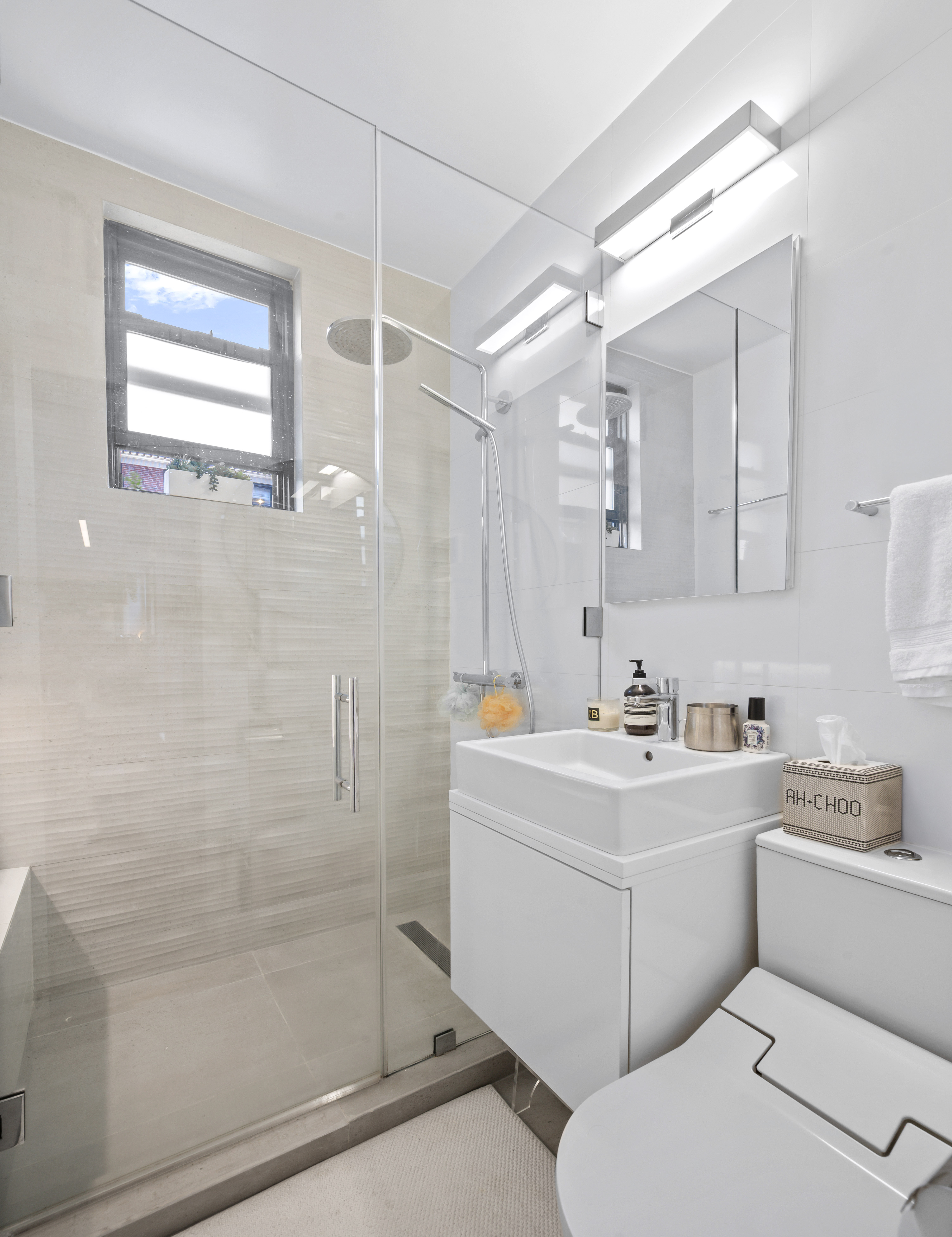 140 West 58th Street, Unit PHA Manhattan, NY 10019 - Photo 11 of 13 a bathroom with a sink a toilet and shower