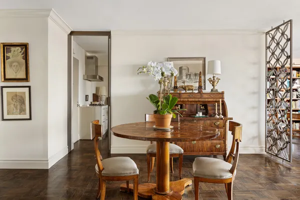 a dining room with furniture and wooden floor