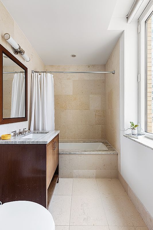 100 Riverside Boulevard, Unit 6C Manhattan, NY 10069 - Photo 5 of 6 a bathroom with a sink a toilet and bathtub