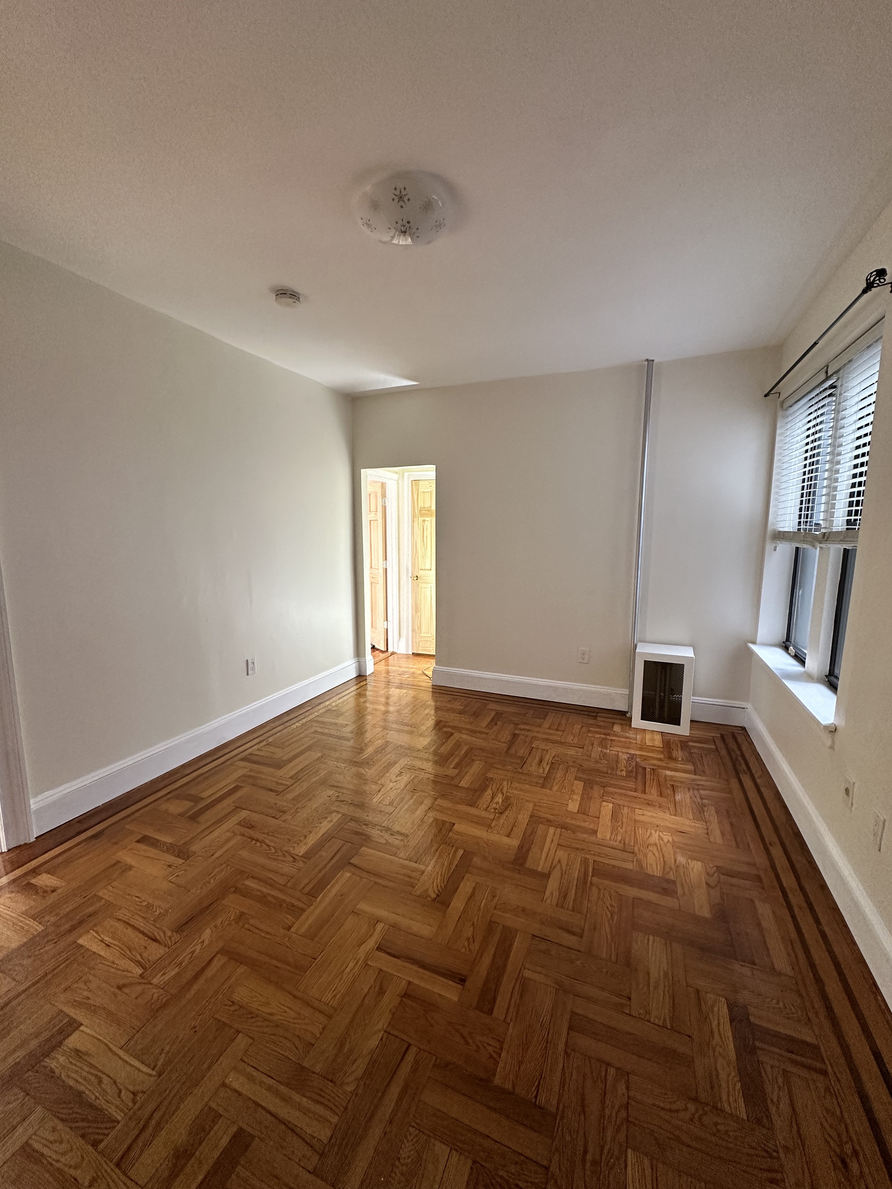 31-40 42nd Street, Unit 1F Queens, NY 11103 - Photo 3 of 9 a view of an empty room and window