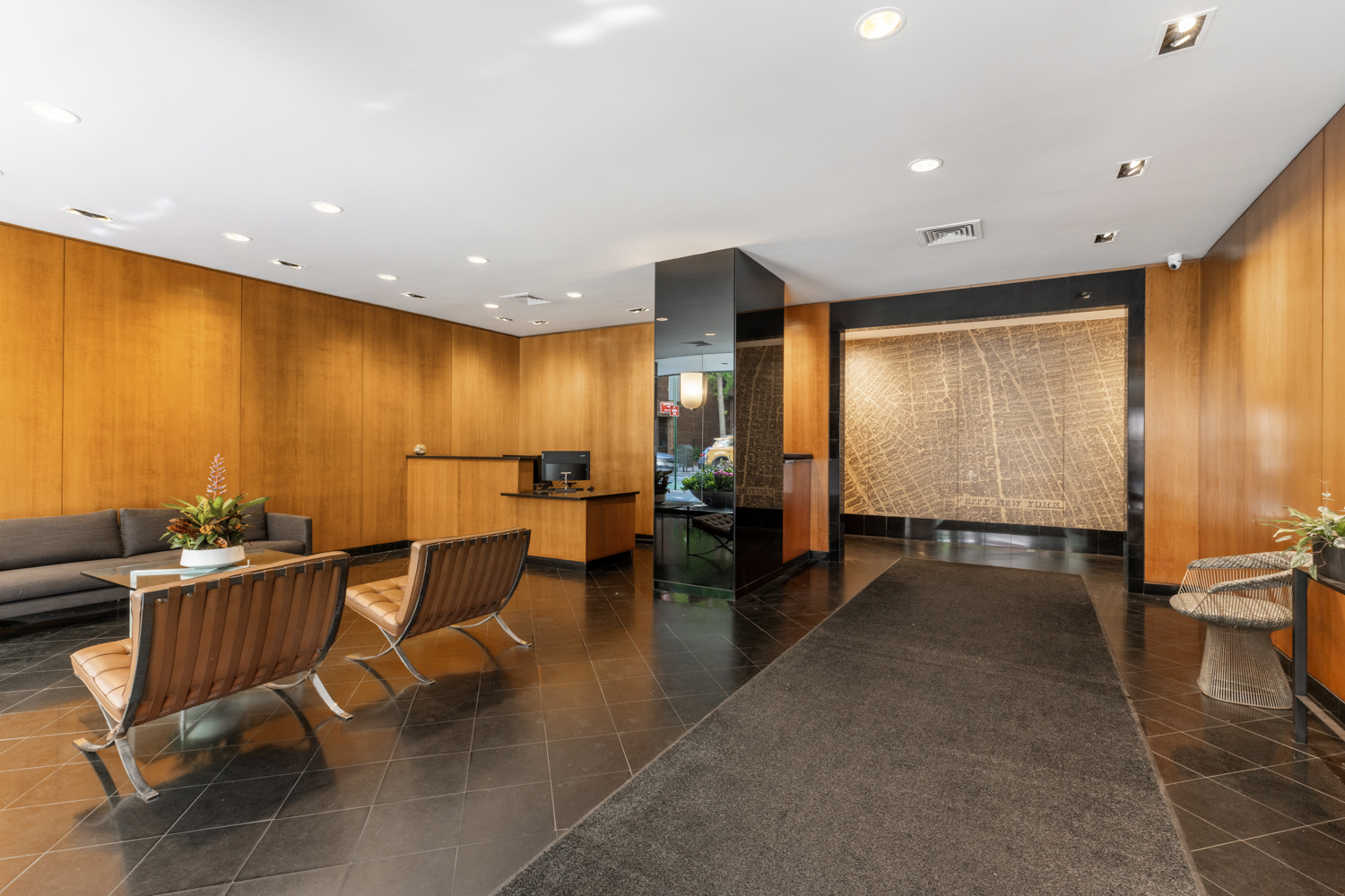 101 West 12th Street, Unit 5V Manhattan, NY 10011 - Photo 25 of 26 a lobby with a table and chairs