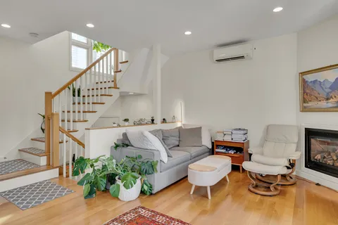 a living room with furniture and a painting