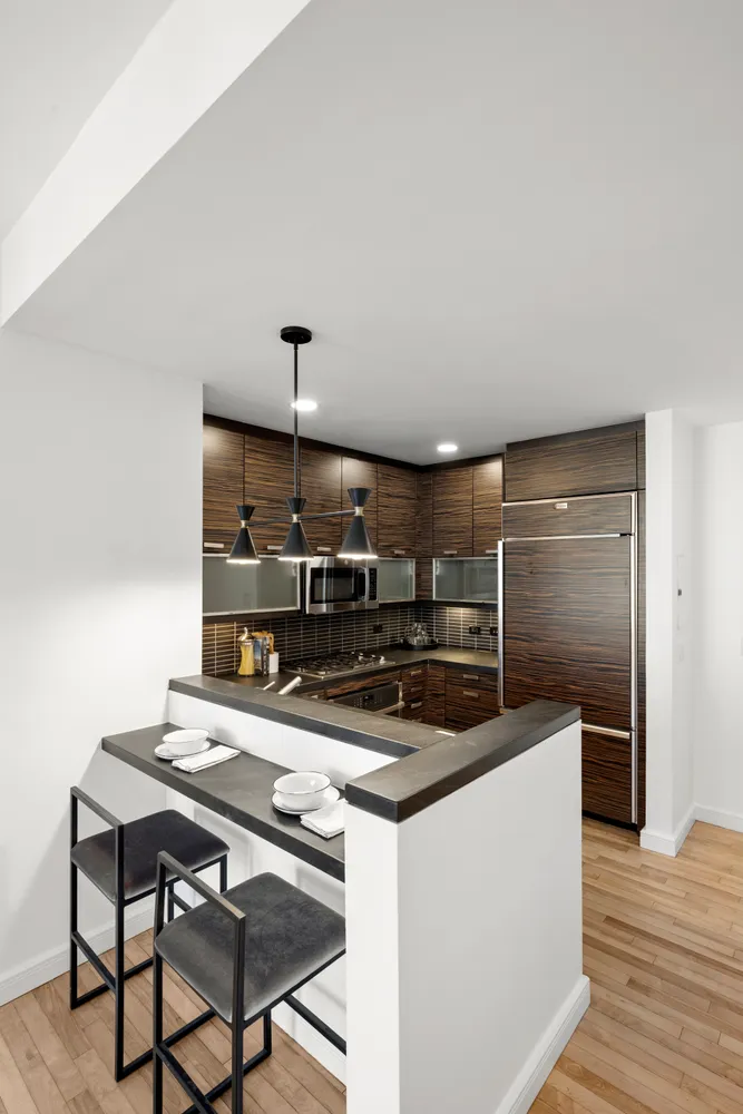 a kitchen with kitchen island a stove and a refrigerator