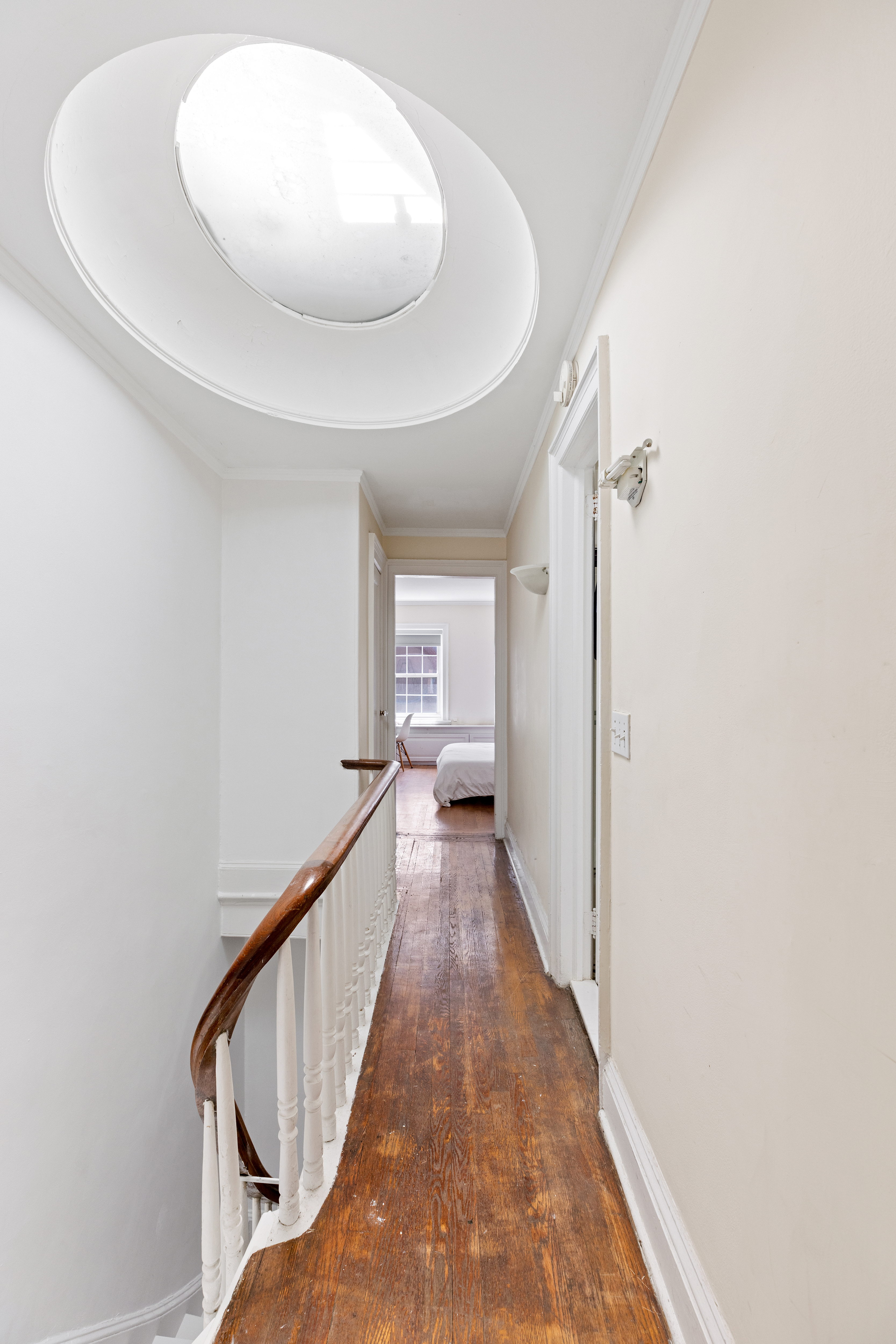 151 East 29th Street, Unit 2 Manhattan, NY 10016 - Photo 10 of 11 a view of a hallway with wooden floor and staircase