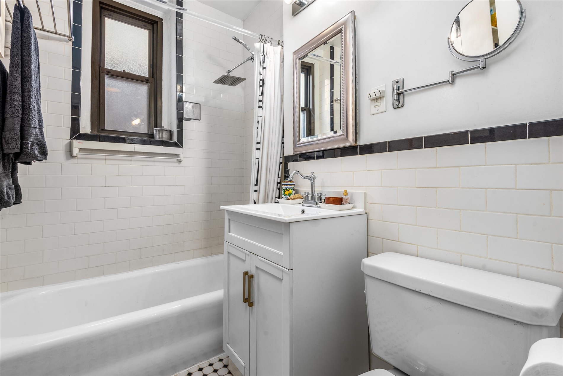 345 East 77th Street, Unit 3C Manhattan, NY 10075 - Photo 6 of 9 a bathroom with a sink toilet and shower