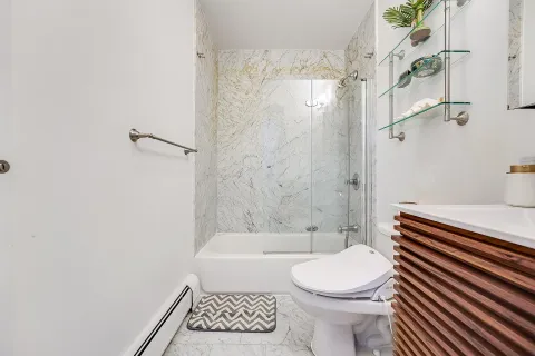 a bathroom with a toilet and a shower