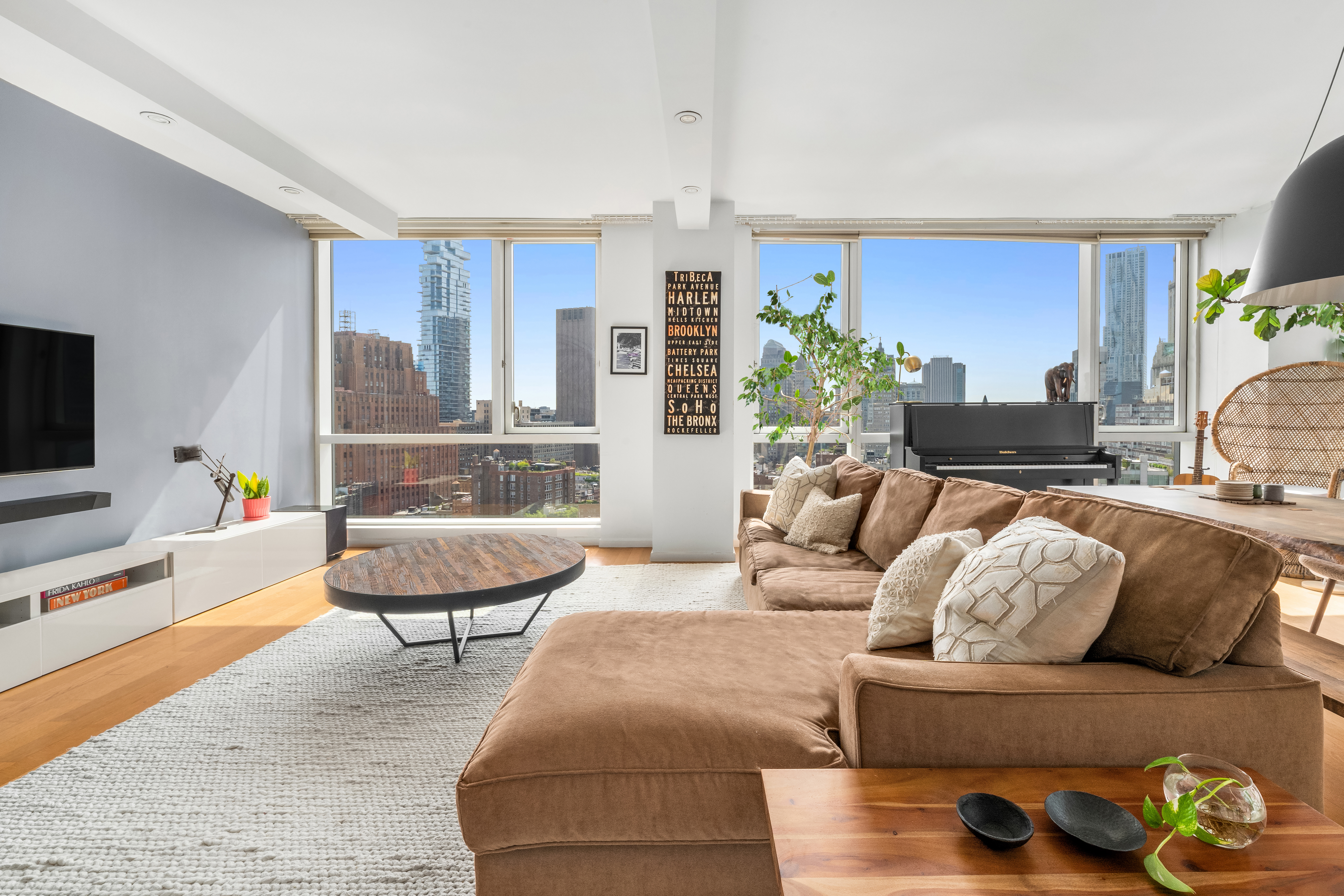 200 Chambers Street, Unit 25F Manhattan, NY 10007 - Photo 3 of 13 a living room with furniture and a flat screen tv
