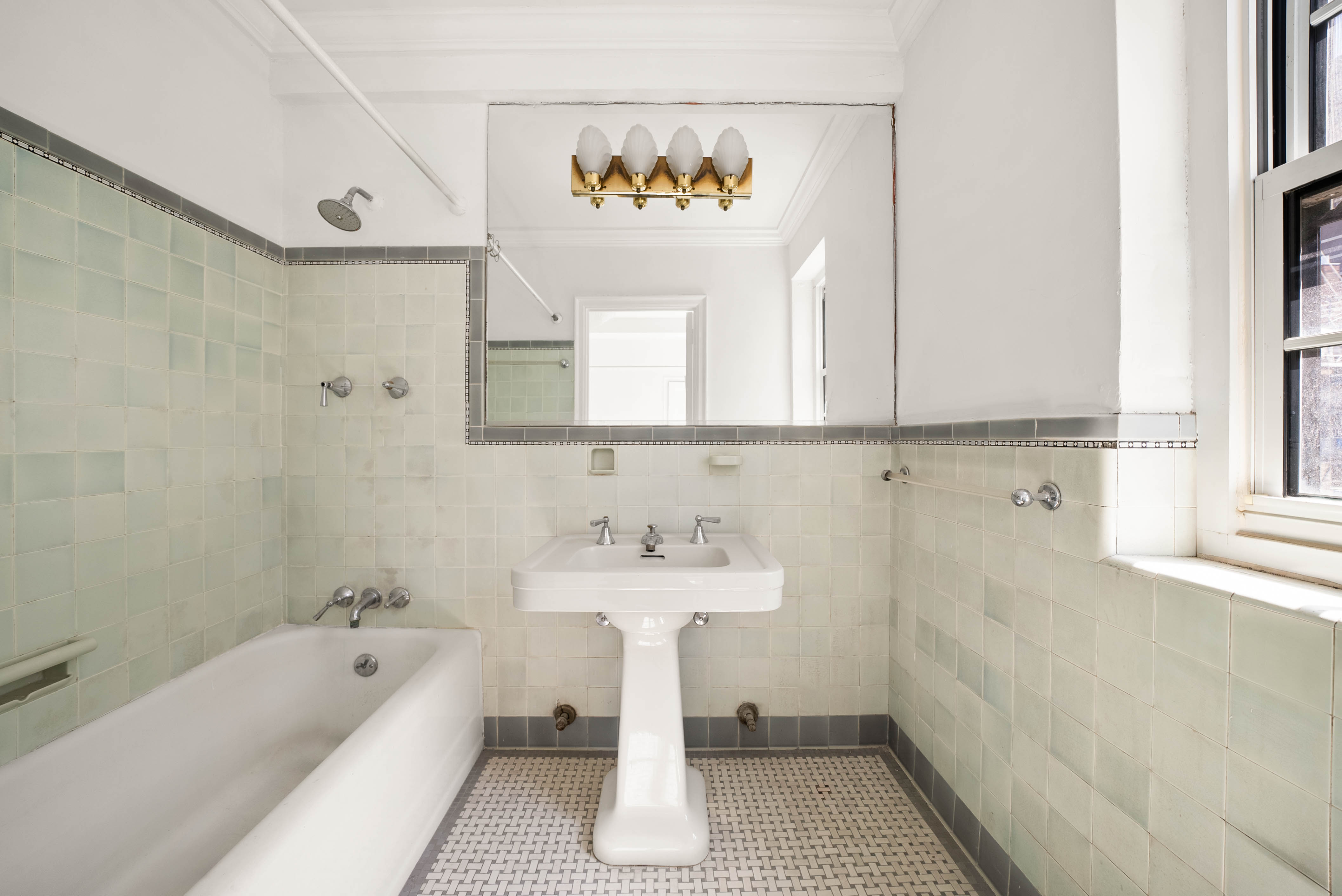 12 East 88th Street, Unit PH11/12B Manhattan, NY 10128 - Photo 10 of 22 a bathroom with a sink a bathtub and a window