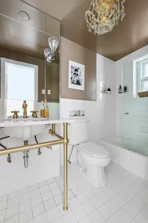 a bathroom with a sink a toilet and a mirror