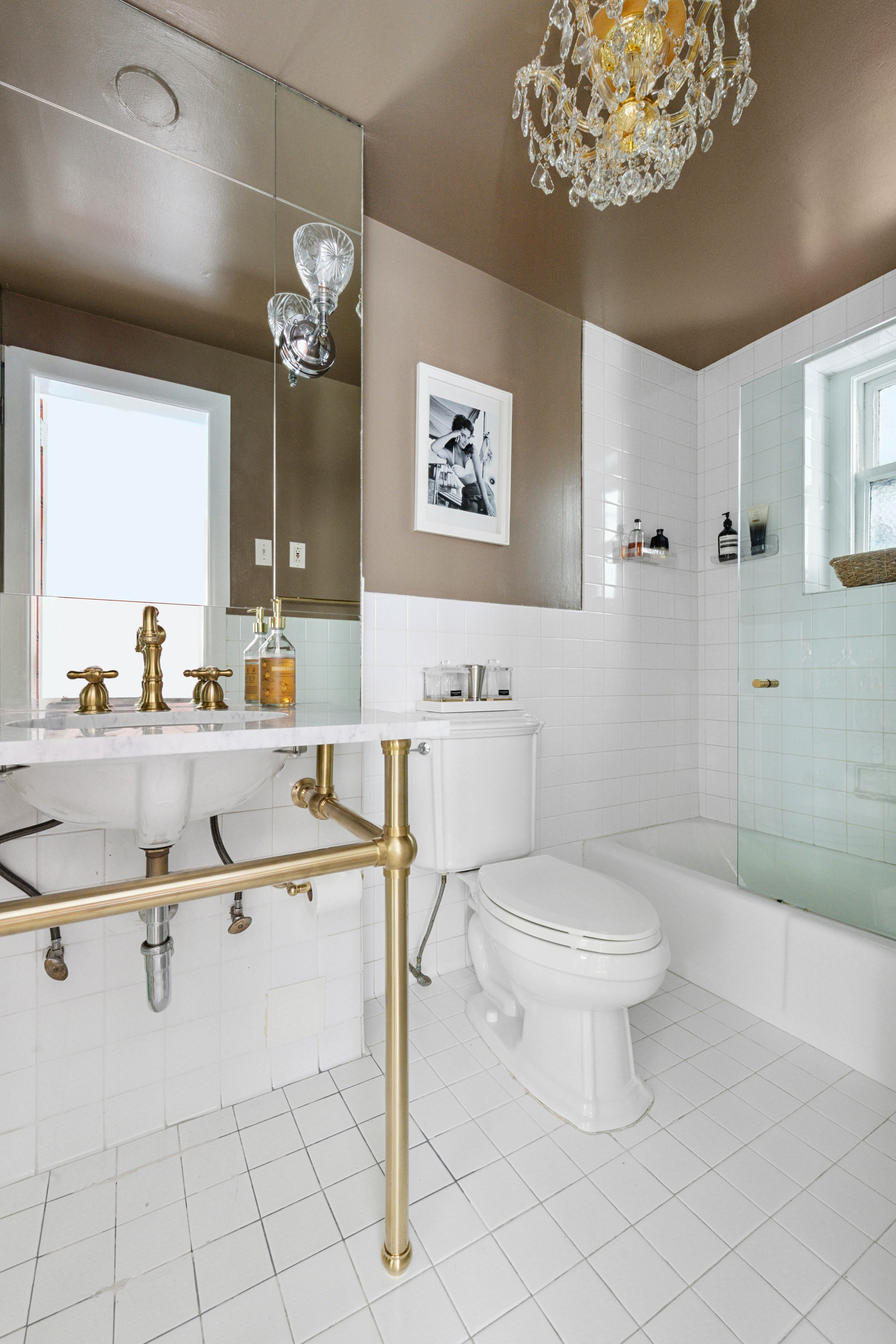 1 West 67th Street, Unit 608 Manhattan, NY 10023 - Photo 9 of 16 a bathroom with a sink a toilet and a mirror