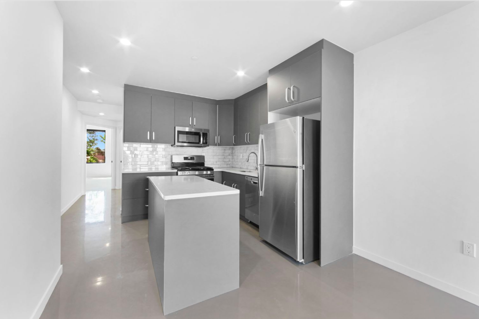 278 Warren Street, Unit 4 Brooklyn, NY 11201 - Photo 3 of 8 a kitchen with stainless steel appliances granite countertop a refrigerator a sink a stove and a refrigerator with wooden floor