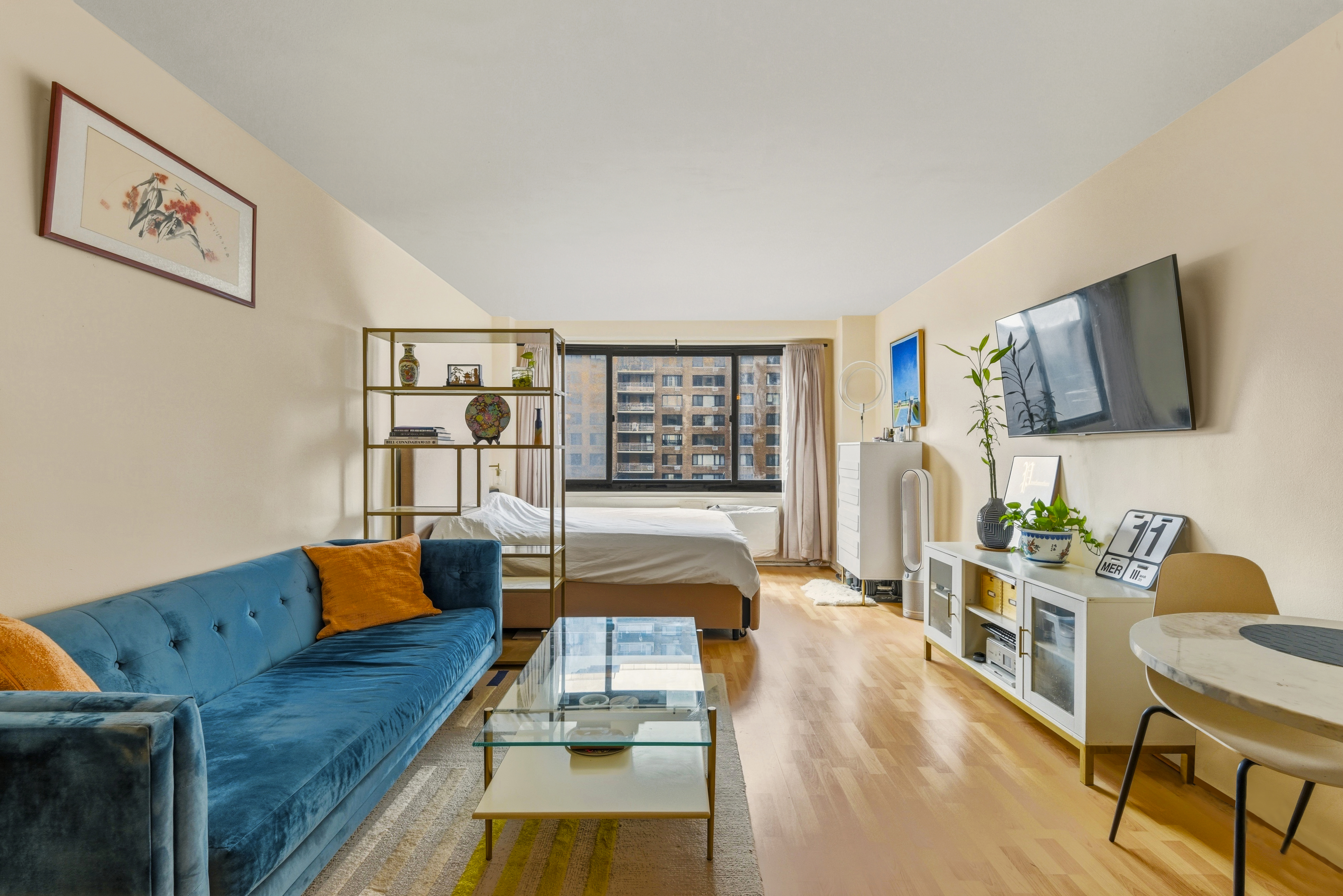 195 Willoughby Avenue, Unit 702 Brooklyn, NY 11205 - Photo 4 of 11 a living room with furniture and a flat screen tv