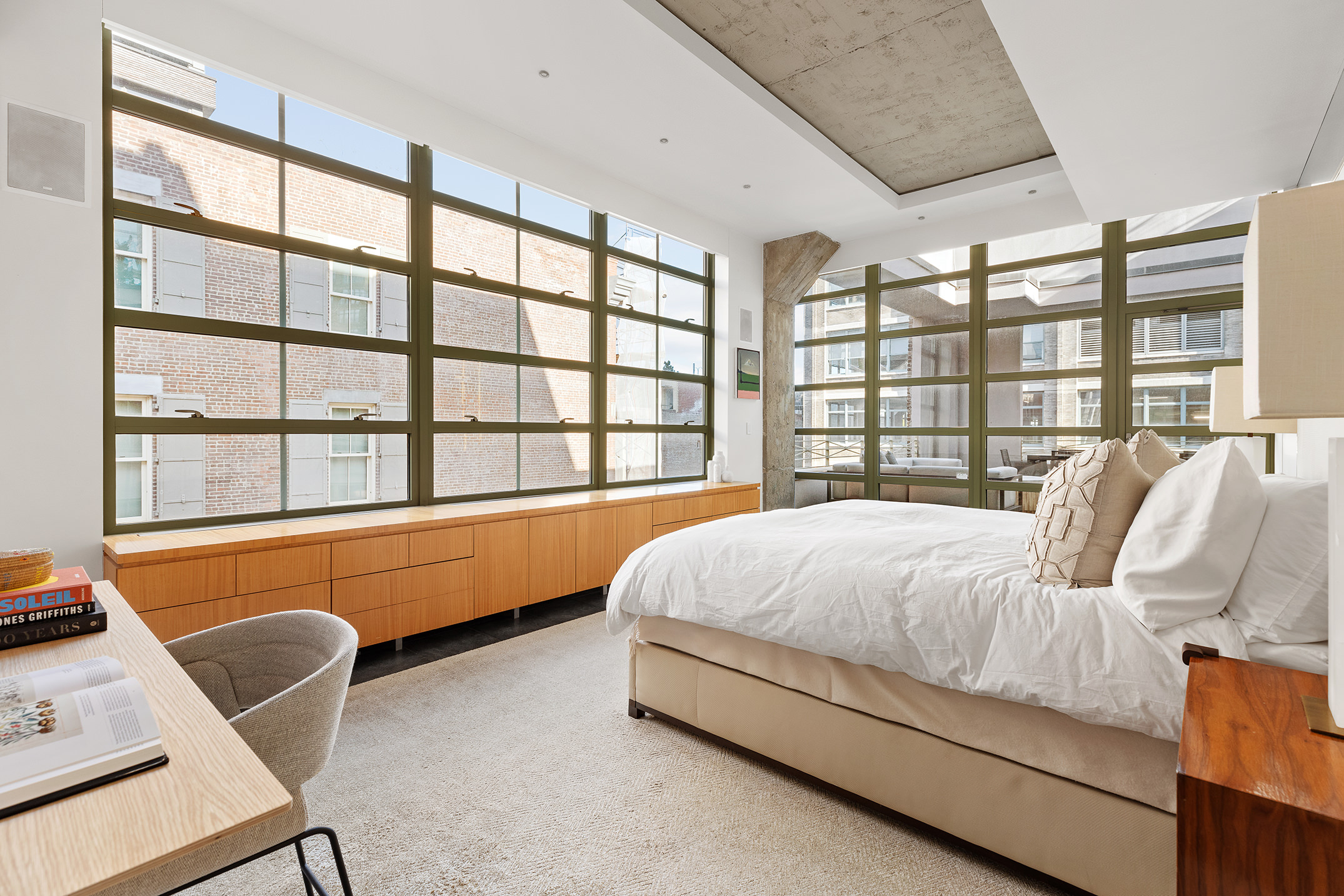 195 Hudson Street, Unit 6A Manhattan, NY 10013 - Photo 11 of 15 a bed sitting in a bedroom next to a window