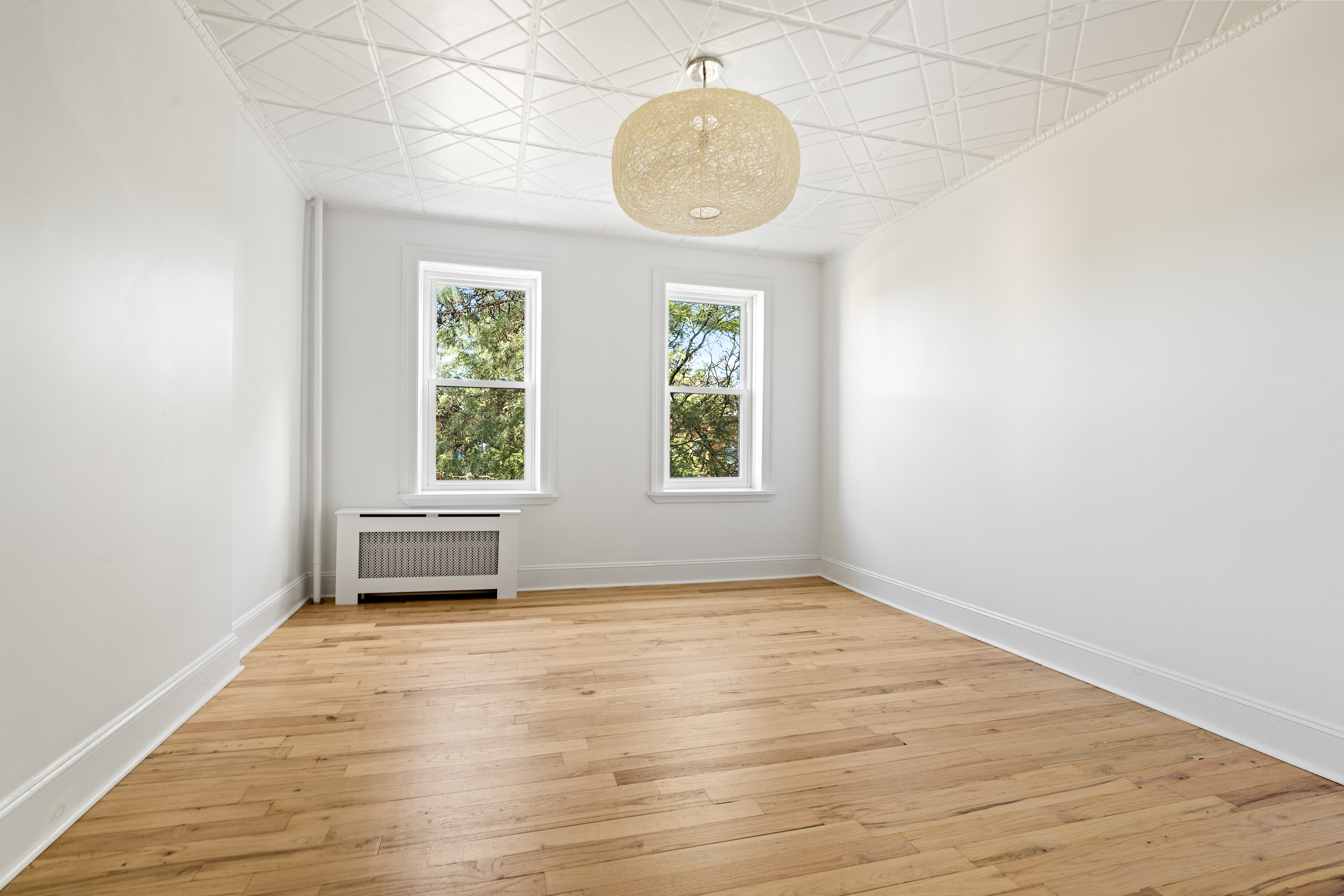 456 Prospect Avenue, Unit 3R Brooklyn, NY 11215 - Photo 2 of 16 an empty room with wooden floor and windows