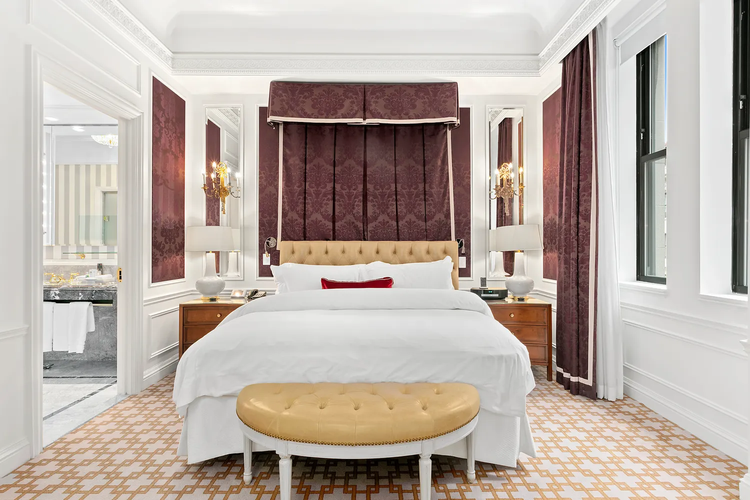 a bed sitting in a bedroom next to a window