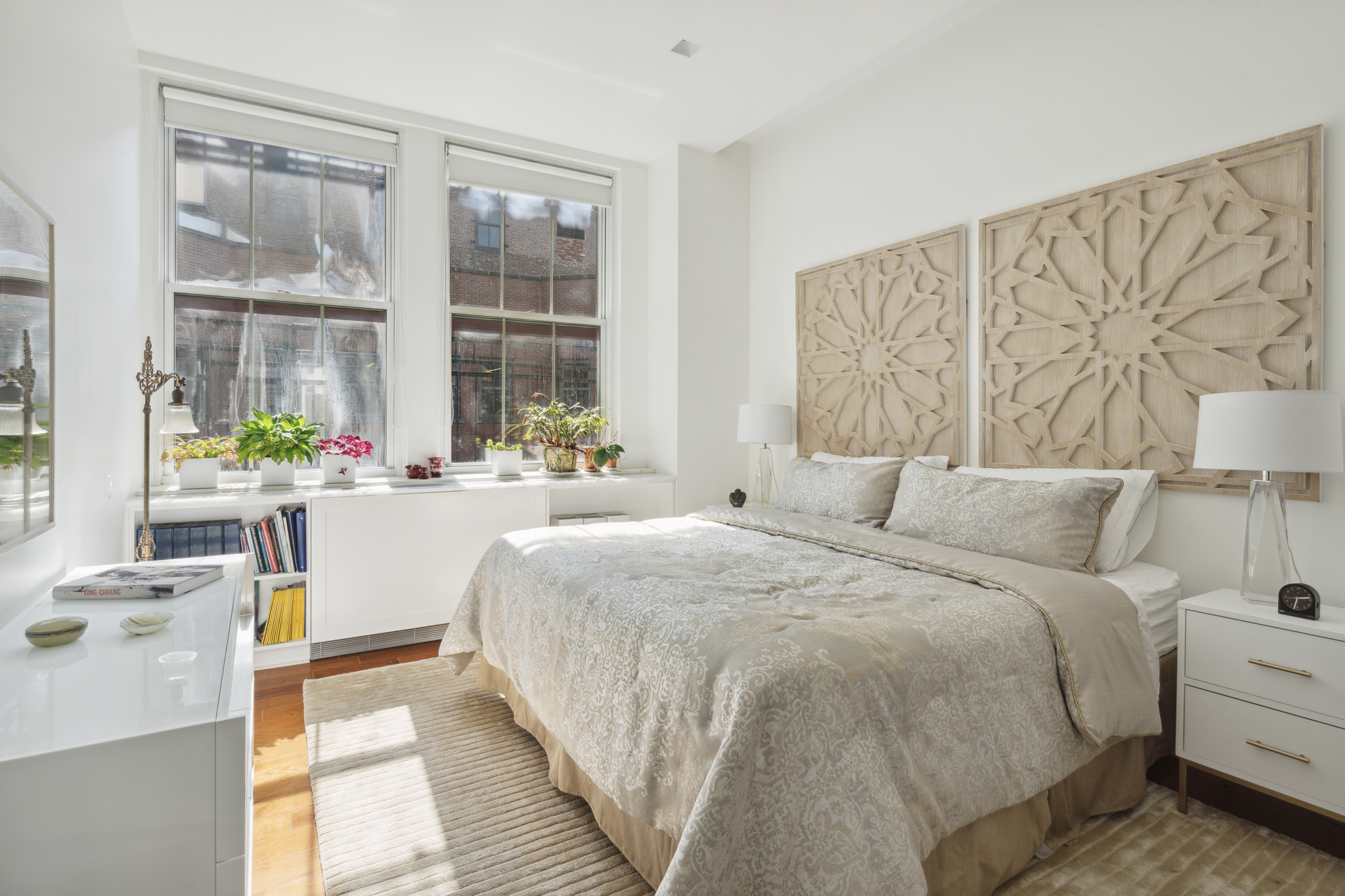 561 Broadway, Unit 10C Manhattan, NY 10012 - Photo 9 of 11 a spacious bedroom with a bed and a large window