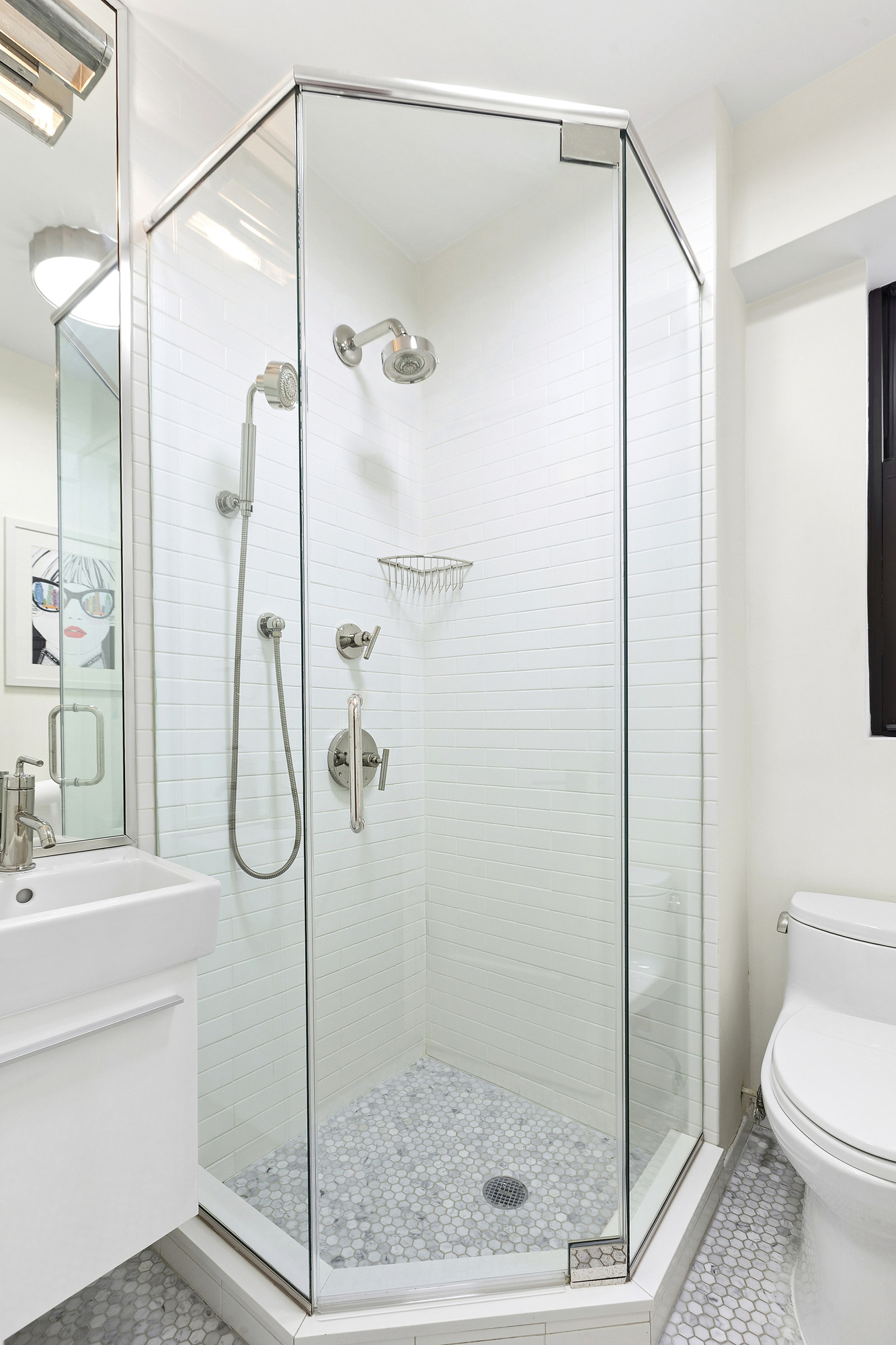 514 West End Avenue, Unit 7B Manhattan, NY 10024 - Photo 7 of 9 a bathroom with a shower and a sink a mirror