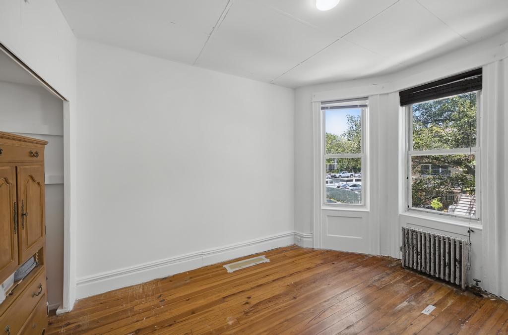 10 Seeley Street Brooklyn, NY 11218 - Photo 17 of 27 a view of an empty room with wooden floor and a window
