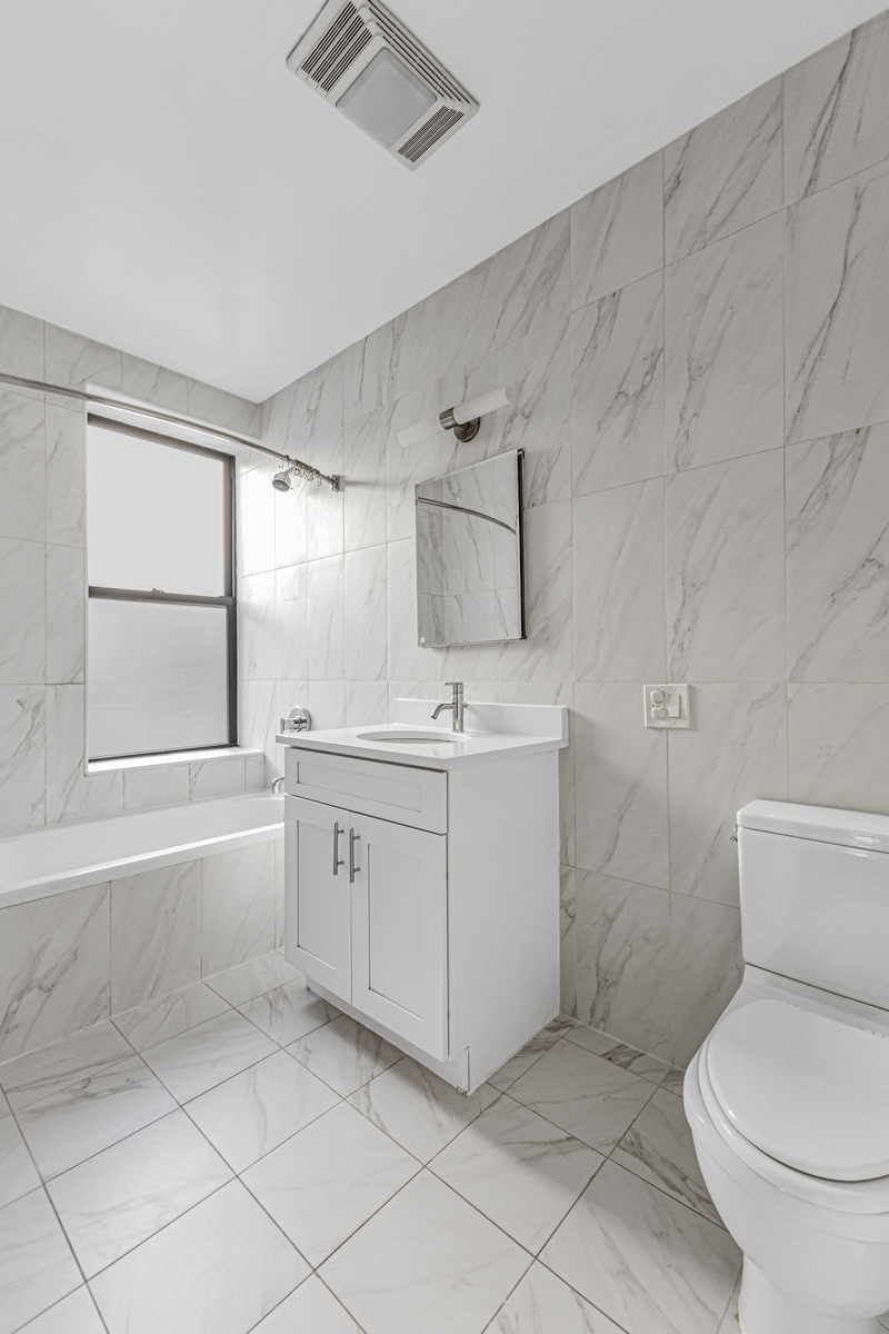 305 West 150th Street, Unit 606 Manhattan, NY 10039 - Photo 6 of 6 a bathroom with a sink toilet and vanity