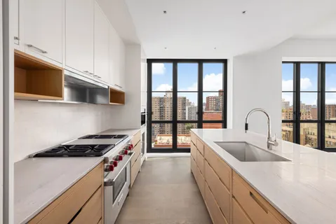 a kitchen with a stove a sink and a microwave