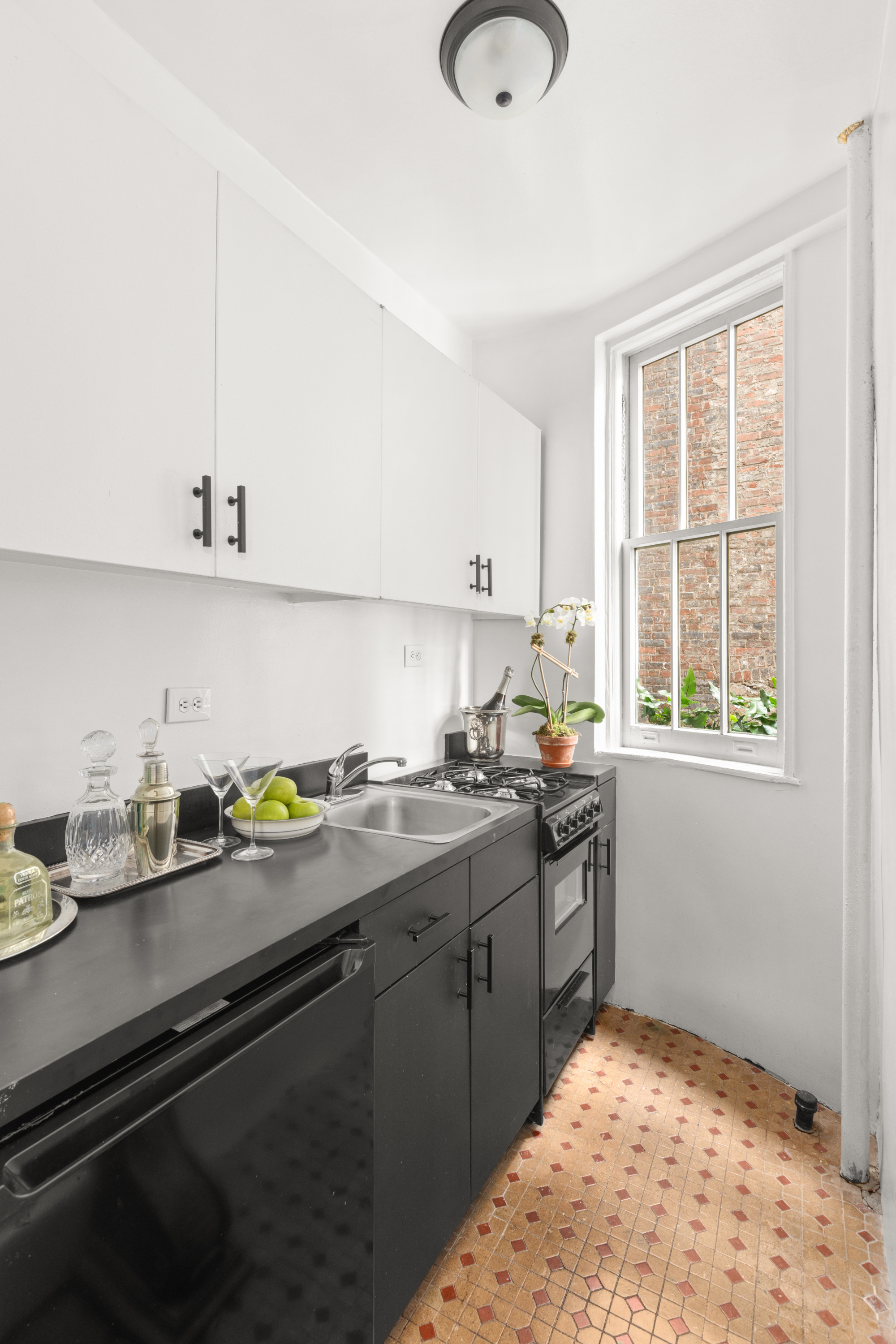 51 East 78th Street, Unit 3BC Manhattan, NY 10075 - Photo 19 of 25 a kitchen with a sink stove and cabinets