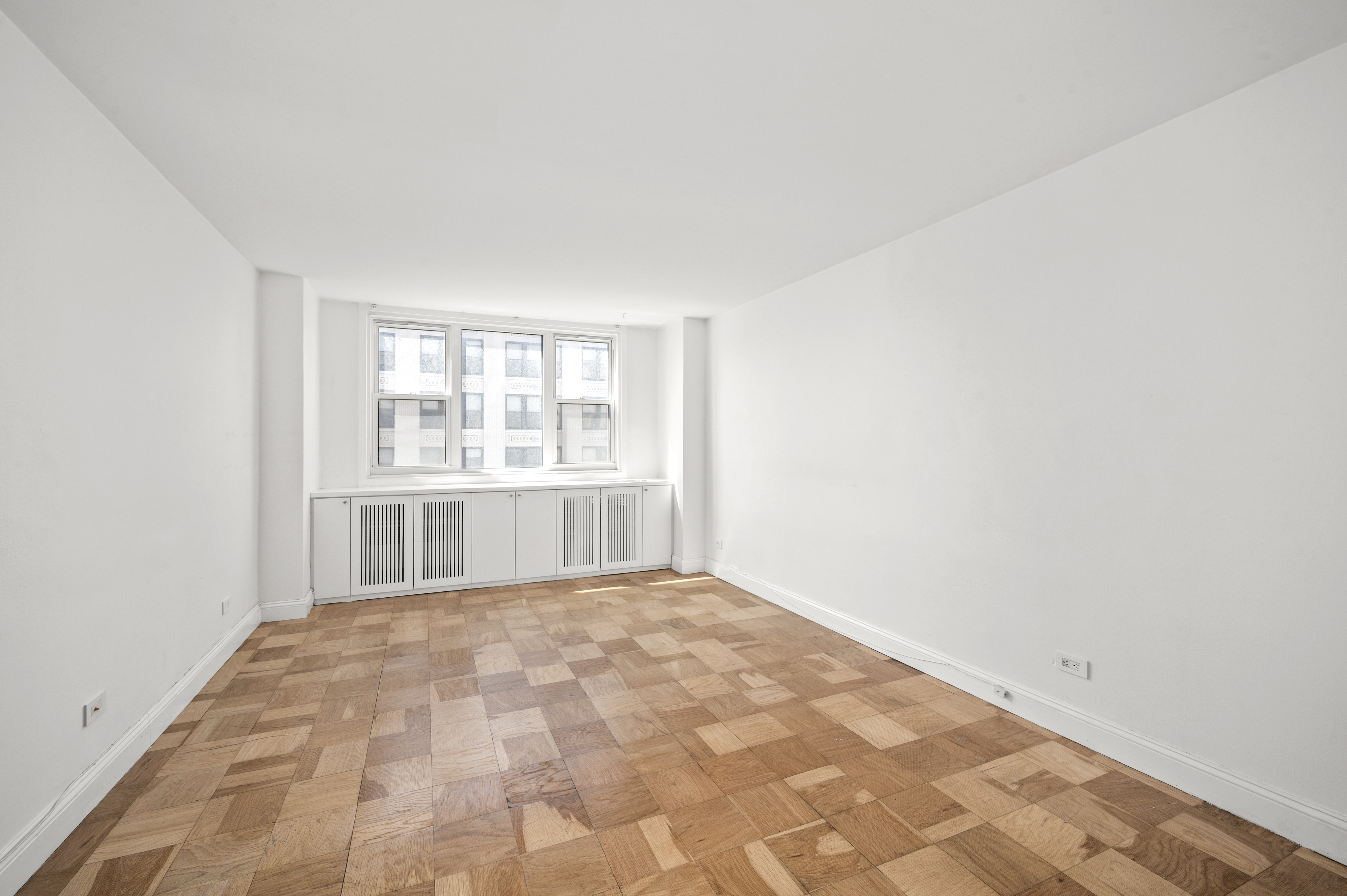77 7th Avenue, Unit 10N Manhattan, NY 10011 - Photo 9 of 13 a view of an empty room with a window