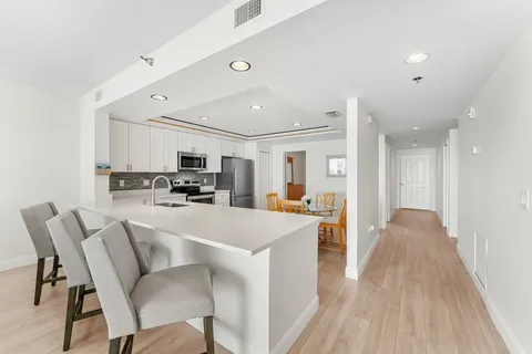 a view of kitchen with cabinets table and chairs