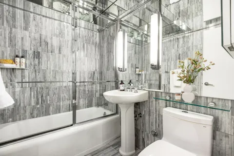 a bathroom with a sink toilet and shower