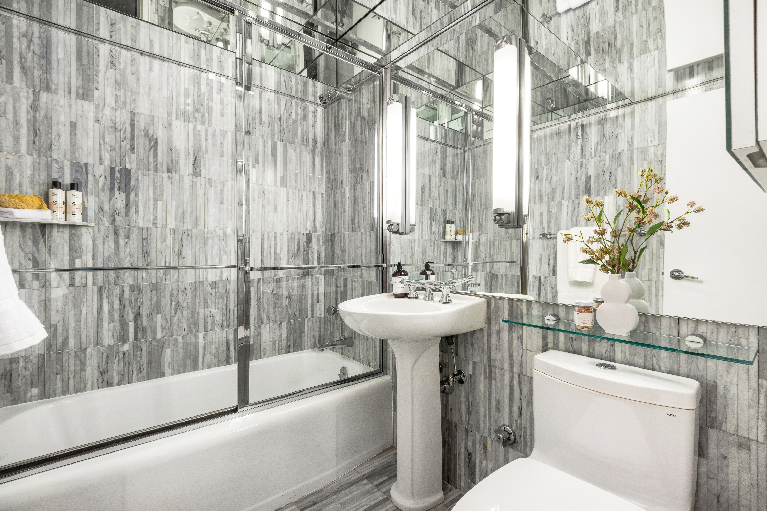 510 East 86th Street, Unit 17C Manhattan, NY 10028 - Photo 26 of 31 a bathroom with a sink toilet and shower
