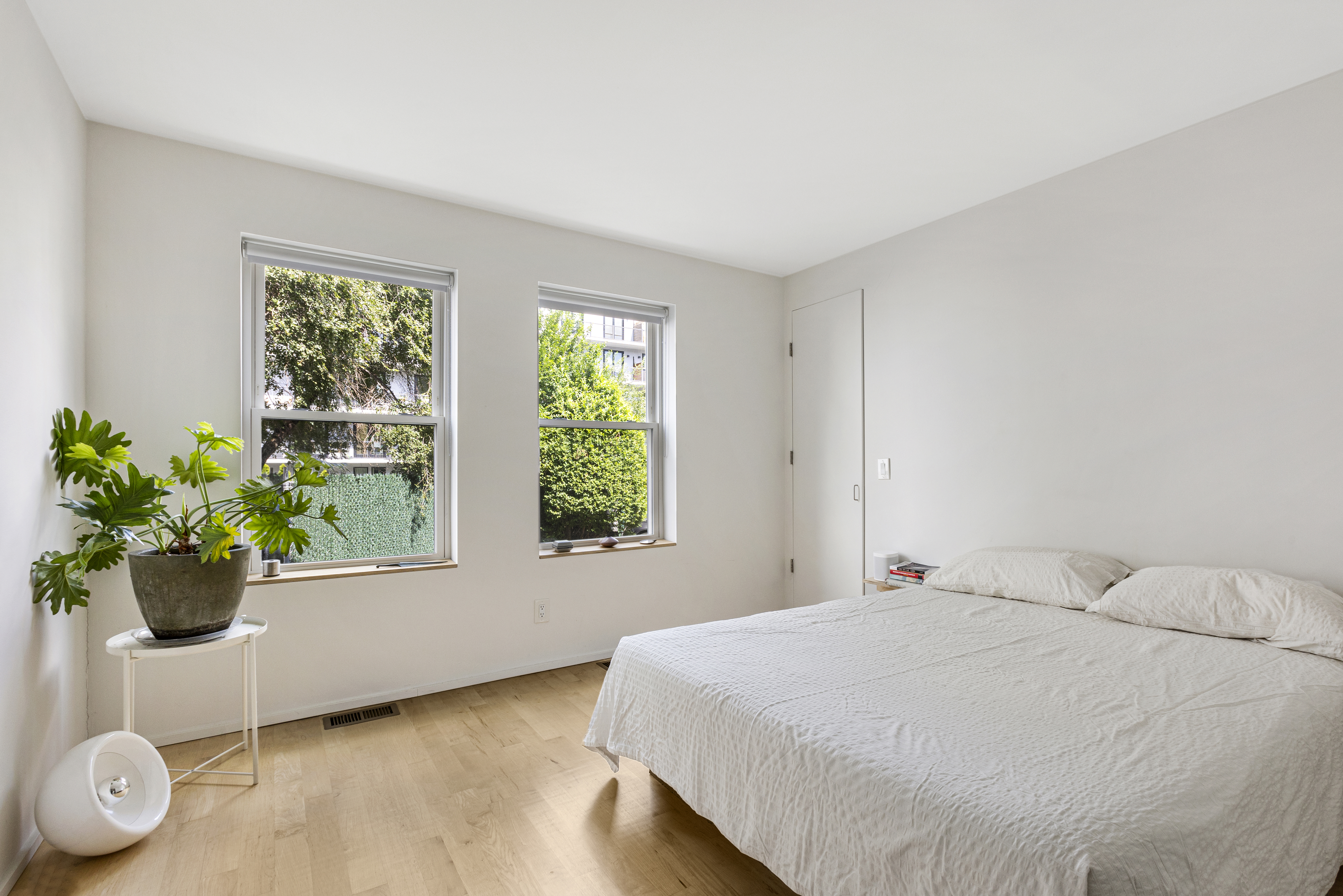 329 Grand Avenue, Unit B Brooklyn, NY 11238 - Photo 5 of 9 a bedroom with a bed and a potted plant