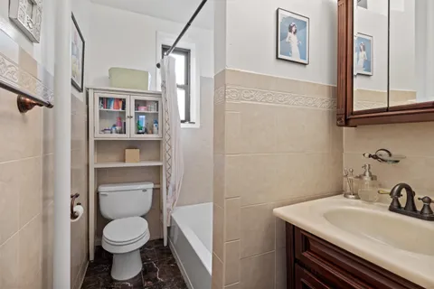 a bathroom with a sink toilet and a mirror