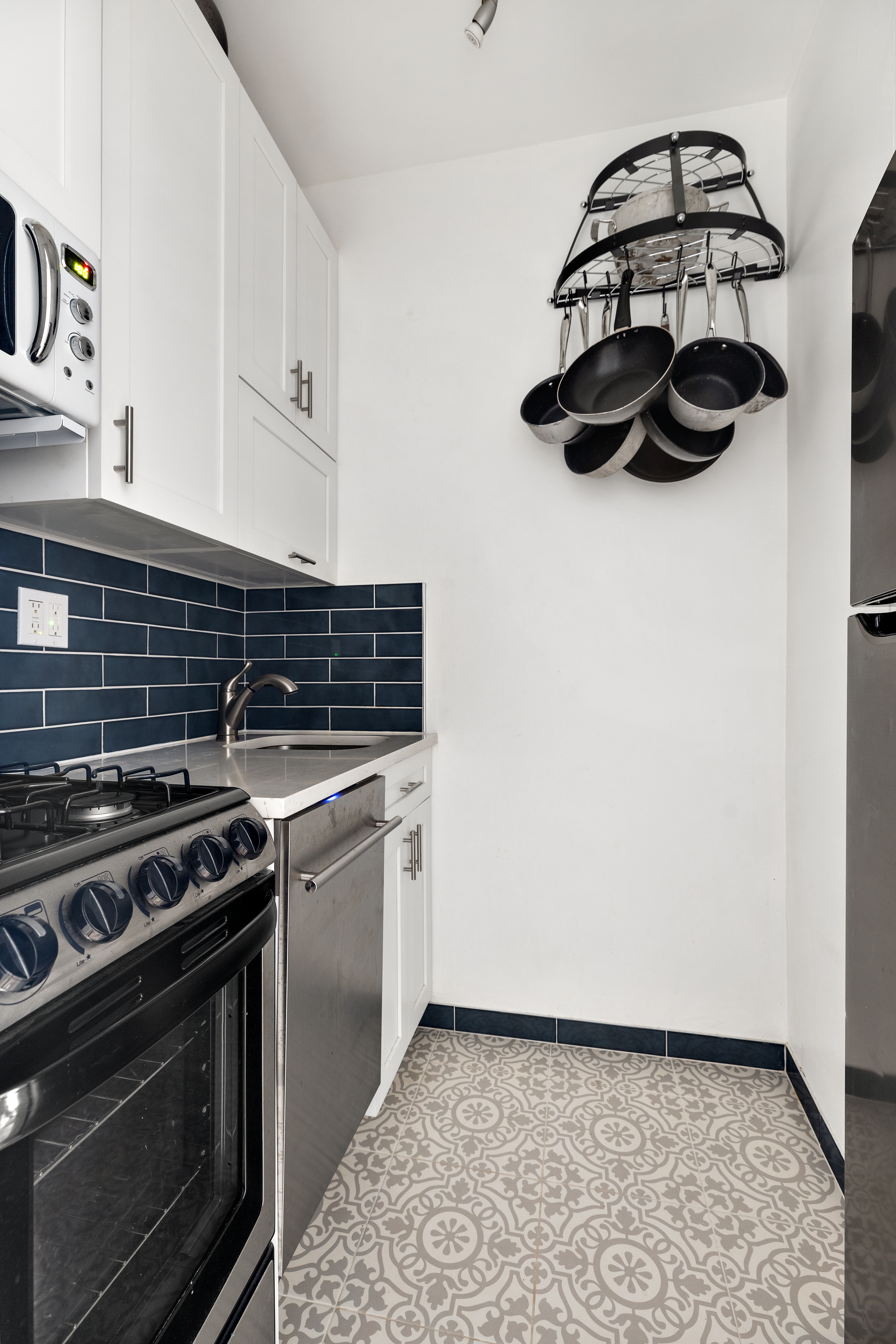 310 East 23rd Street, Unit 5H Manhattan, NY 10010 - Photo 3 of 8 a stove top oven sitting inside of a kitchen