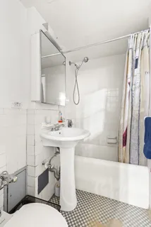 a bathroom with a sink toilet a mirror and shower