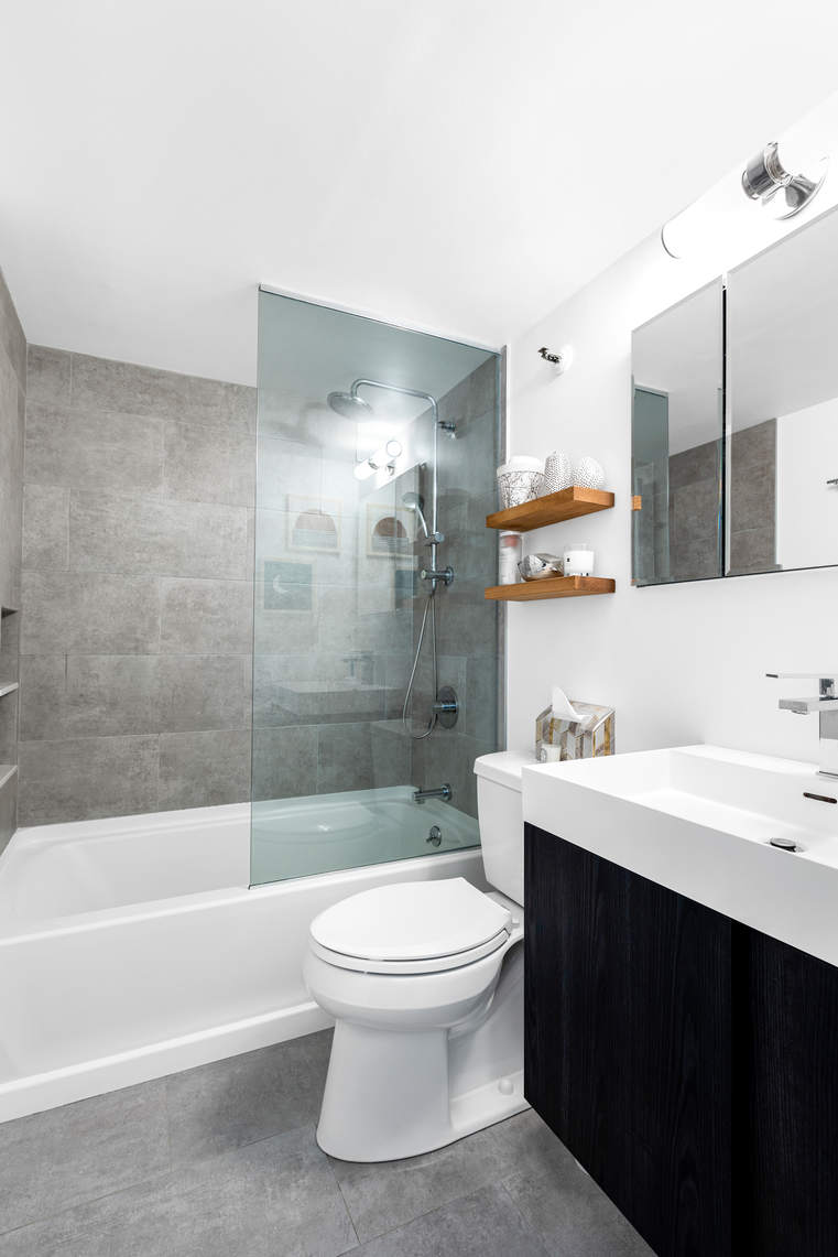 77 Bleecker Street, Unit 819 Manhattan, NY 10012 - Photo 8 of 9 a bathroom with a sink a toilet and shower