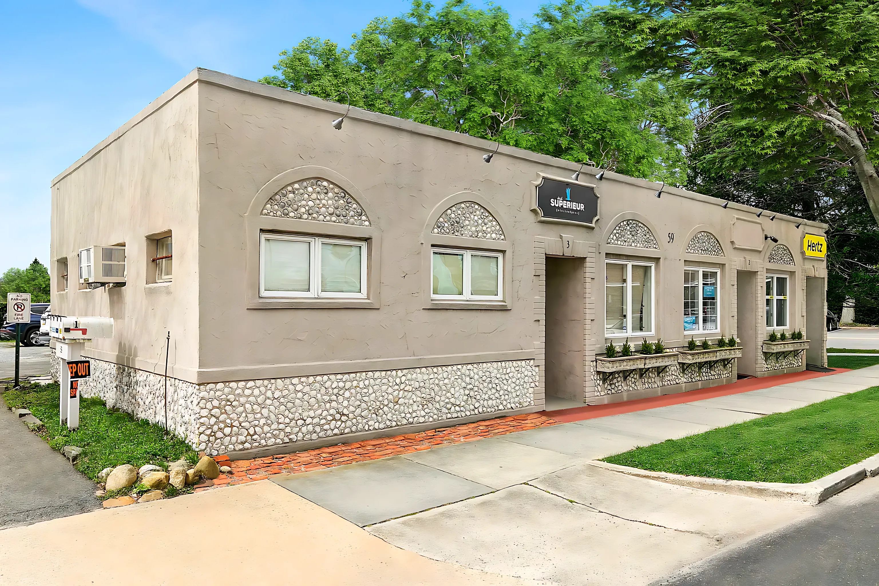 59 Maple Street Southampton, NY 11968 - Photo 3 of 6 a view of a white house with a small yard and large tree