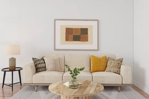 a living room with furniture and a potted plant