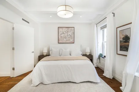 a bedroom with a large bed and a window