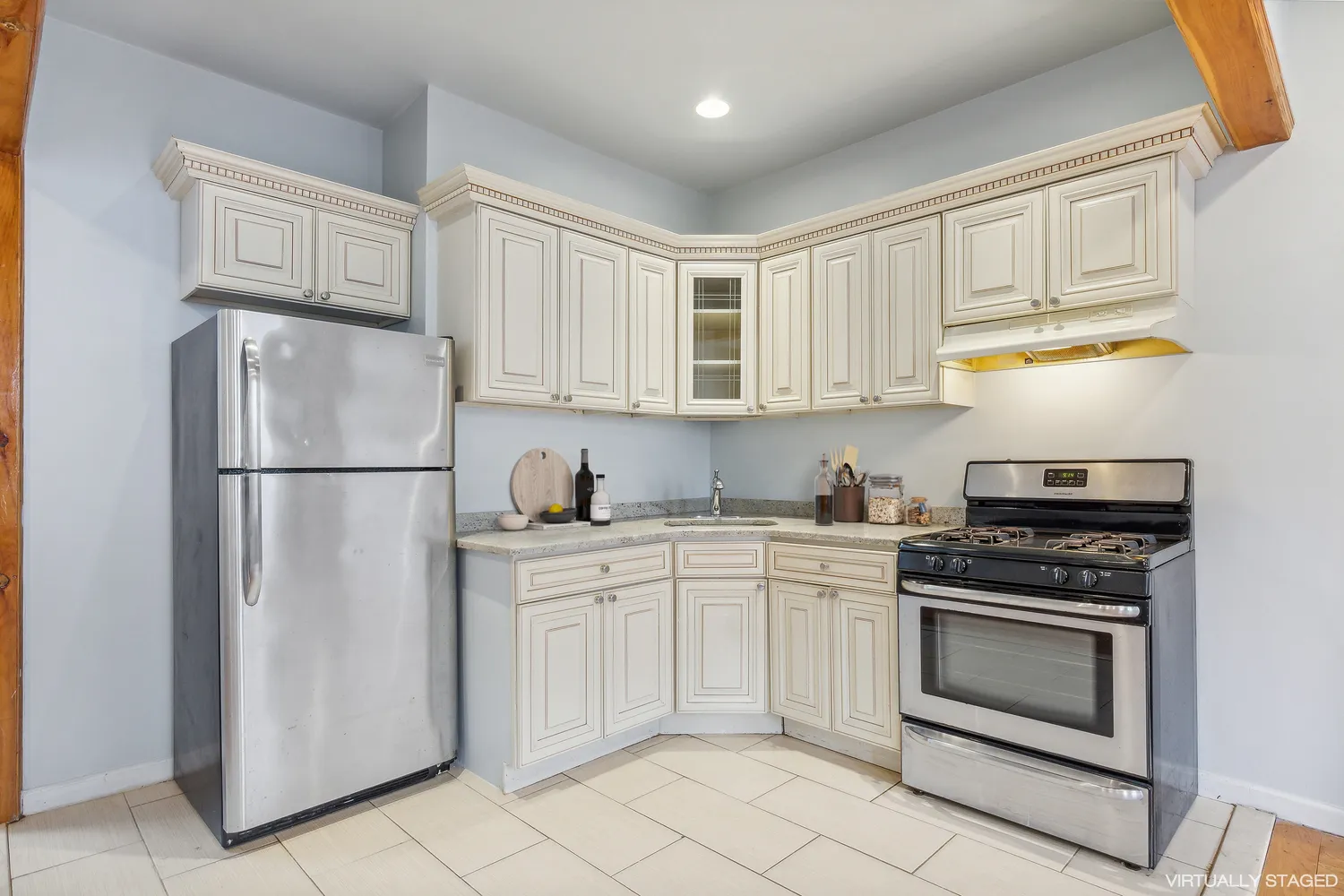 a kitchen with cabinets stainless steel appliances and a counter space