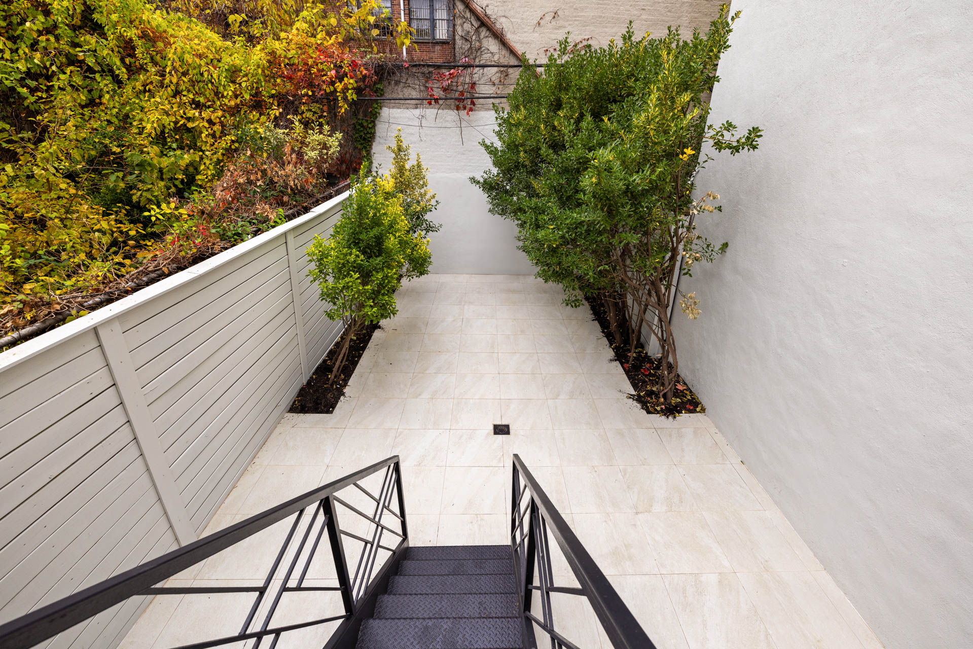 429 Decatur Street Brooklyn, NY 11233 - Photo 15 of 18 a view of balcony with wooden floor and fence