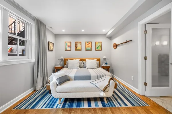 a bedroom with a bed and a large window