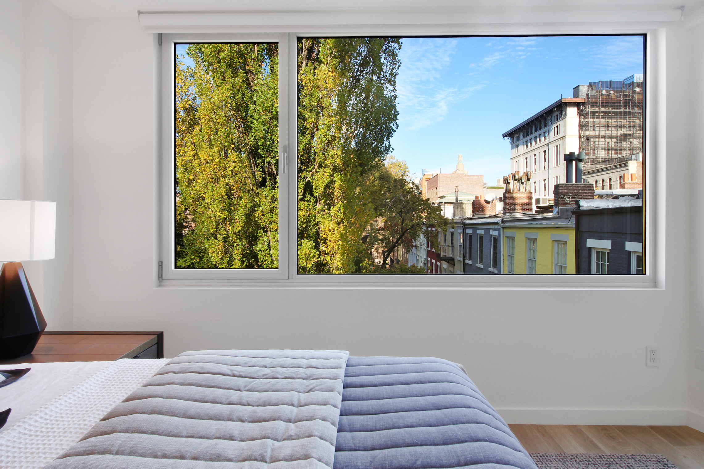 136 West Houston Street, Unit 6 Manhattan, NY 10012 - Photo 10 of 14 a bedroom with a bed and a window