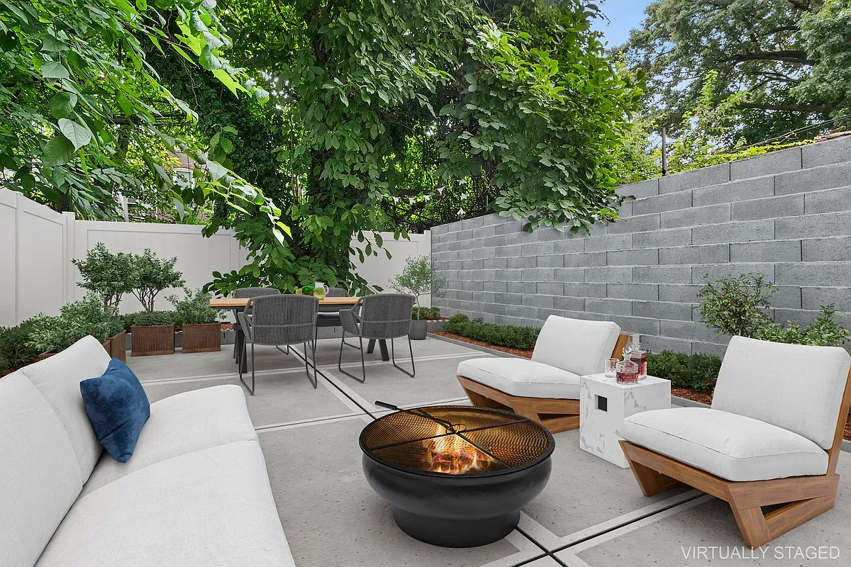 a view of a patio with table and chairs potted plants and a large tree